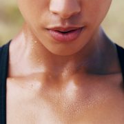 A woman sweating after a strenuous training session.