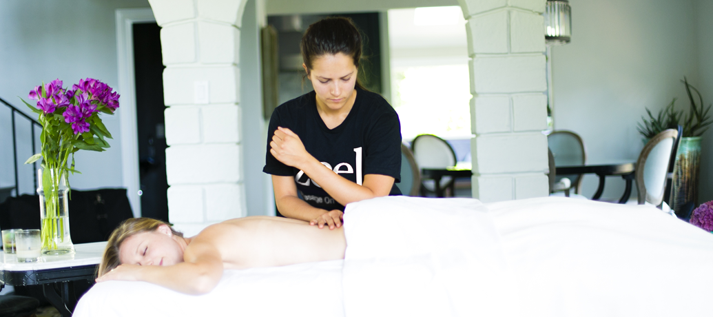 A Zeel Massage Therapist performs skilled work on a client during an in-home massage.