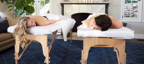 Couples smile at each other in post massage glow after a relaxing Zeel Couples Massage at home