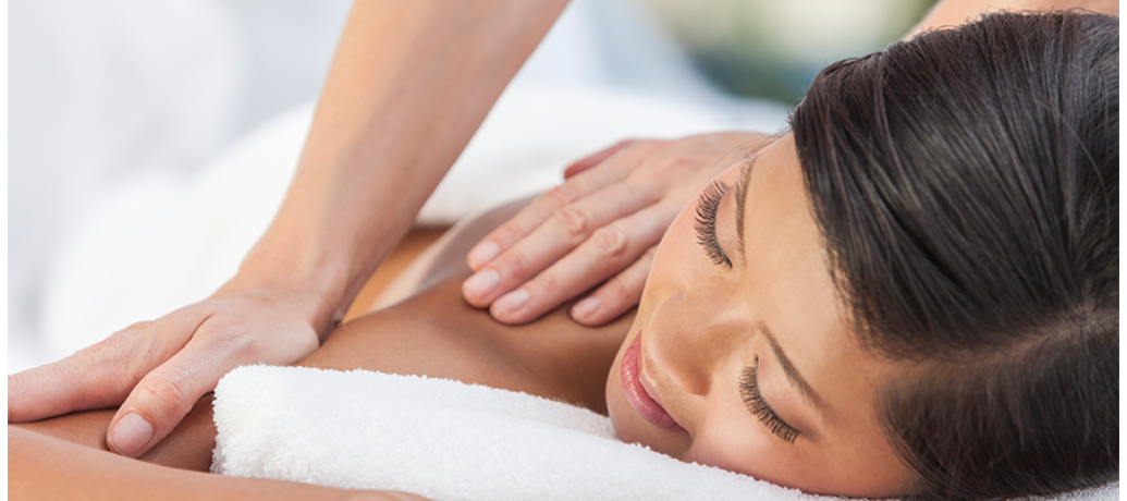 Woman enjoys a Zeel massage, aiding relaxation and weight loss.