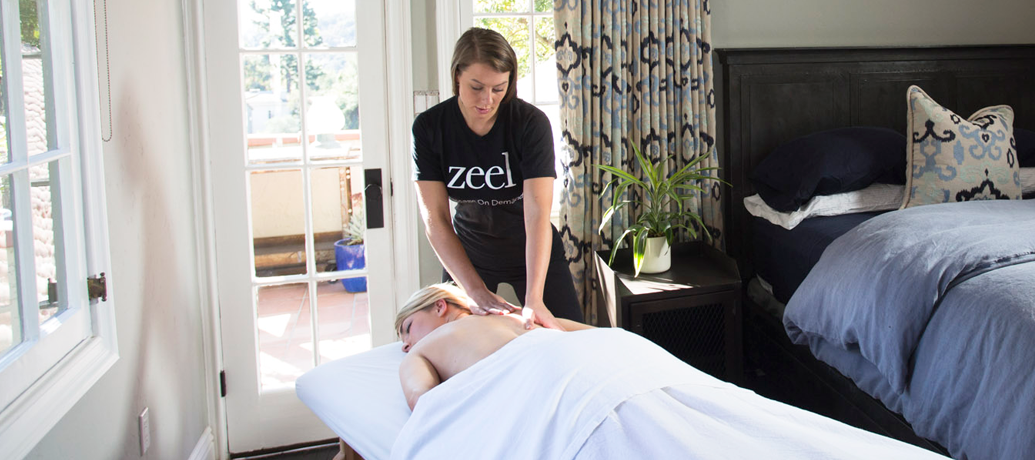 Woman enjoys a relaxing Zeel massage in the comfort of her own bedroom.