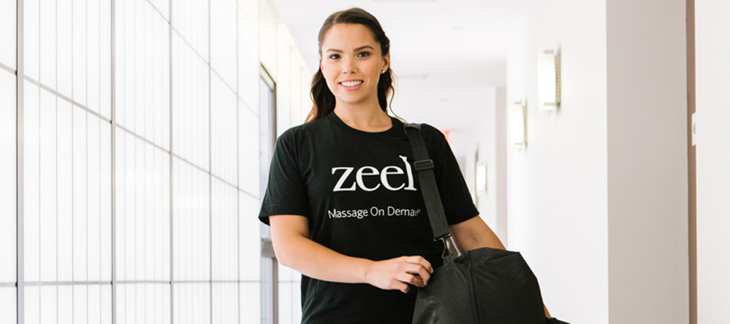 Smiling Zeel Massage Therapist heads to a booked appointment.