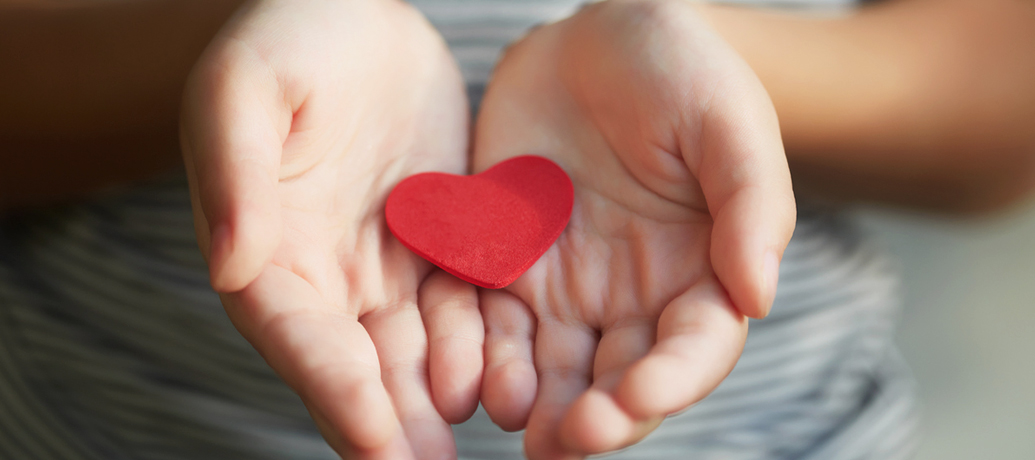 Hands holding red heart