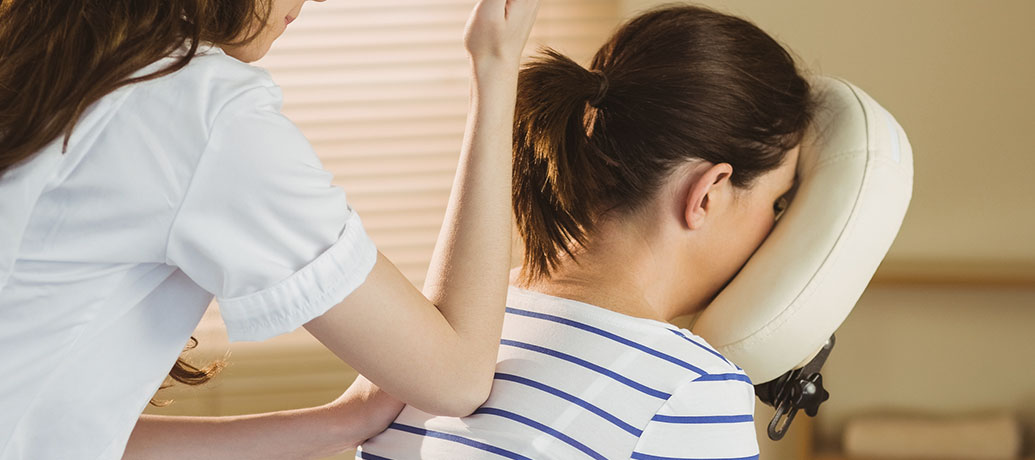 Woman getting a chair massage at work