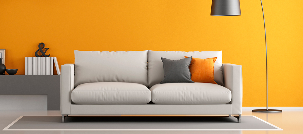 Orange room with couch and lamp