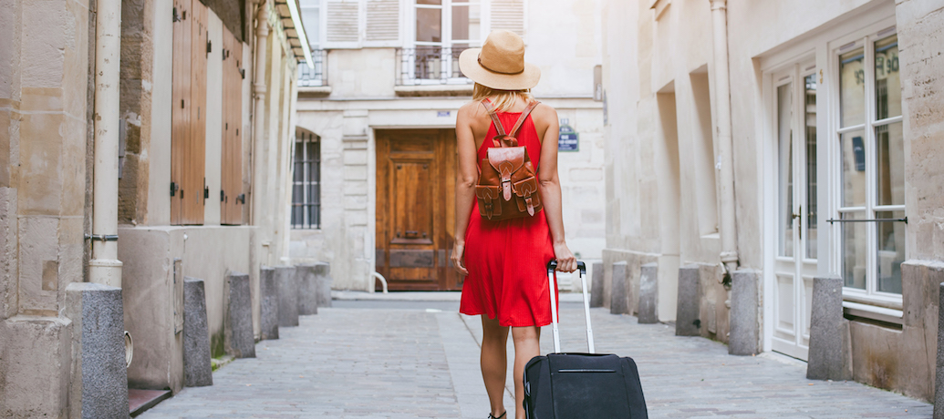 traveler on vacation with rolling suitcase