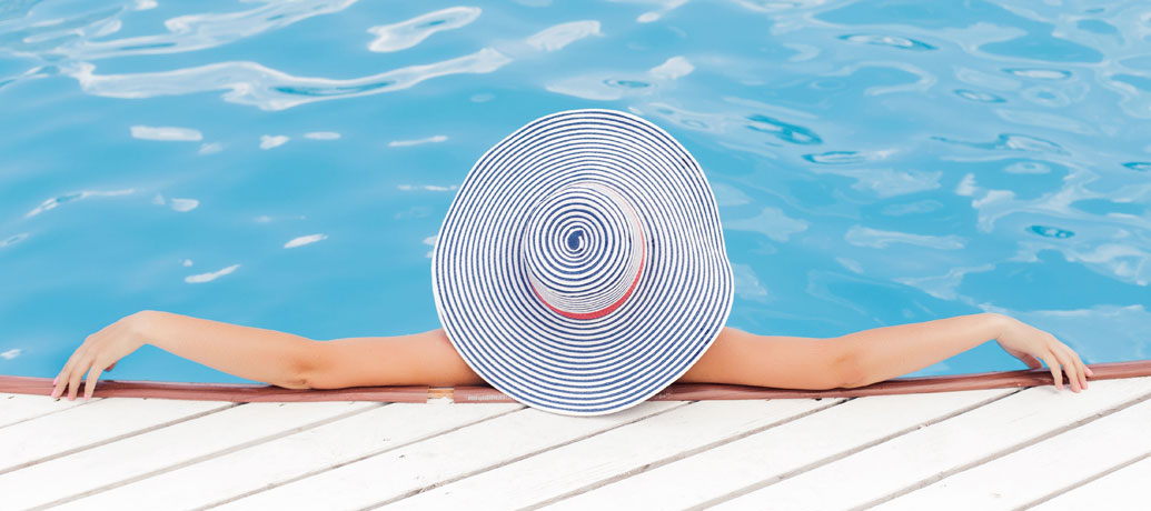 Woman relaxing by the pool getting ready for a Zeel Massage