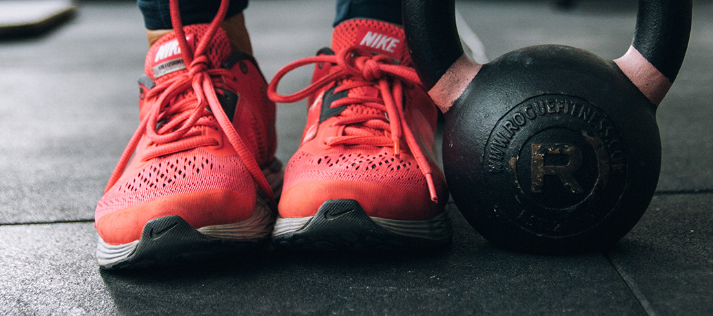 Sneakers and barbell at gym