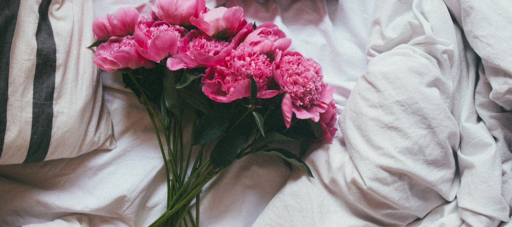Valentine's Day flowers on bed