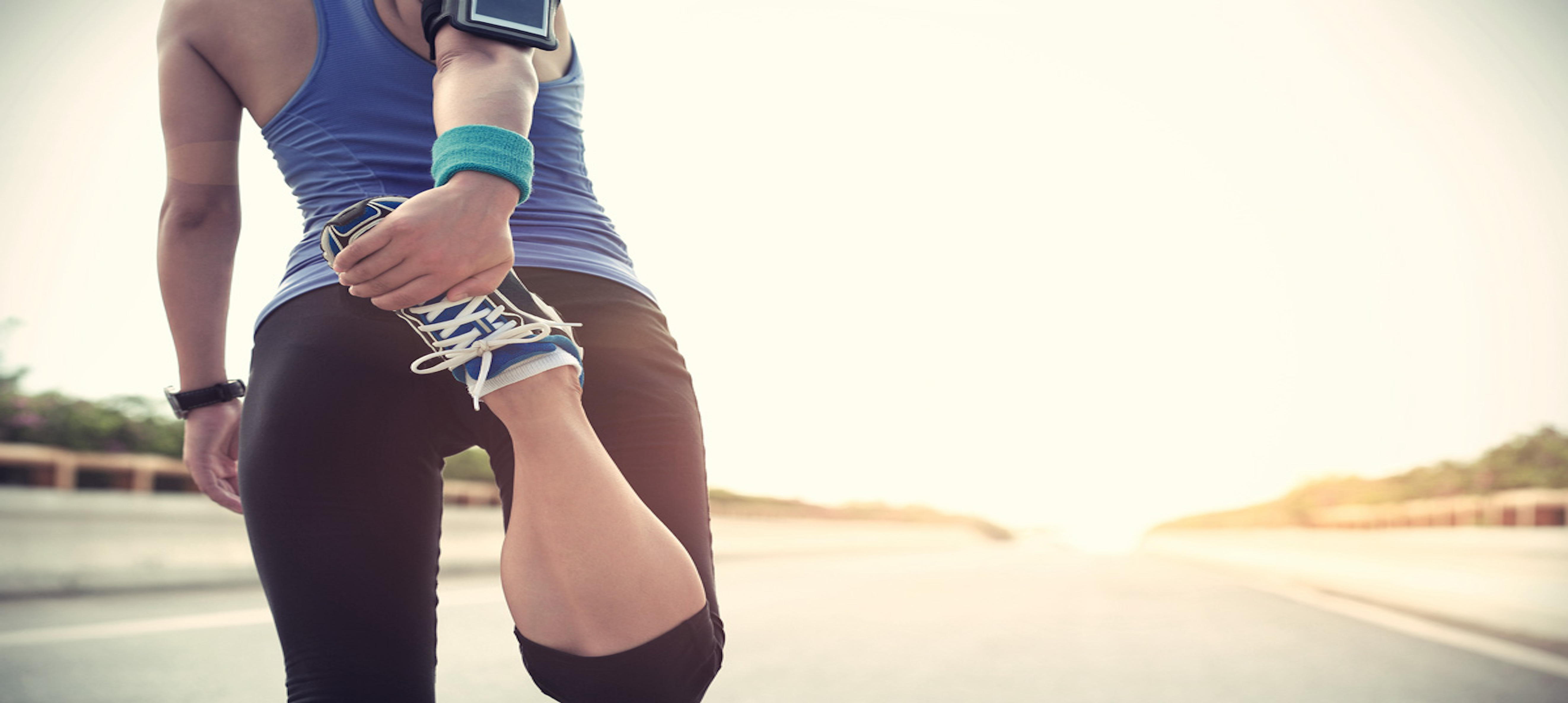 A female runner stretching before her race.