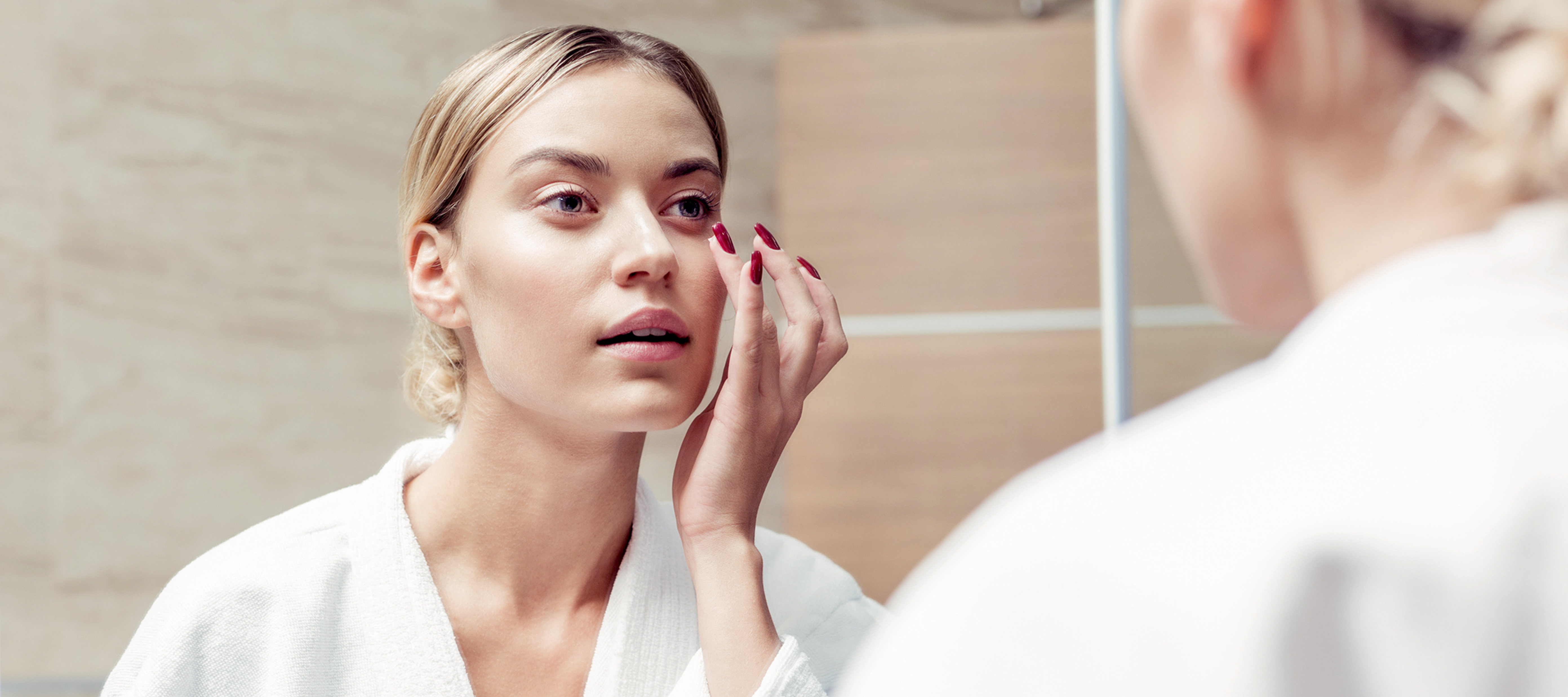 A woman with puffy eyes freshening up in the morning.