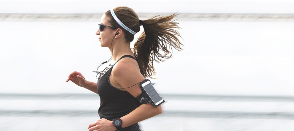 A woman taking a run for National Wellness Day.