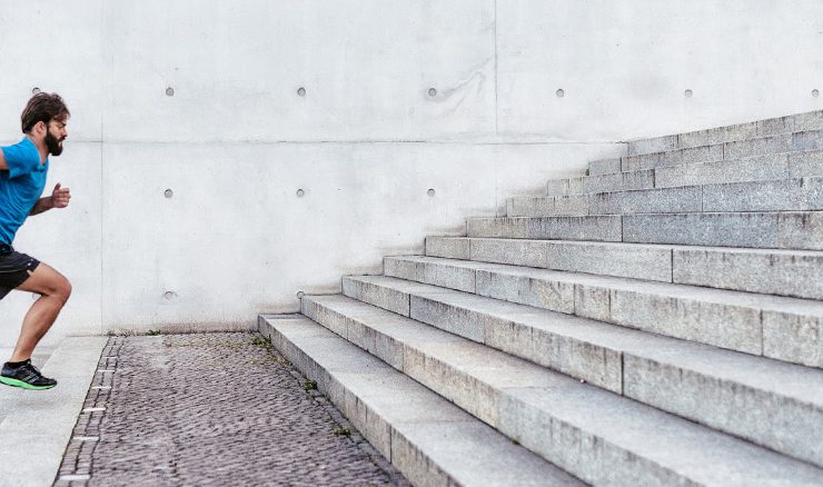 A man running up a set of stairs for his new year's resolution.