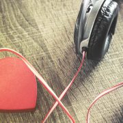 A pair of headphones plugged into a heart to represent massage music for couples to use on Valentine's Day.