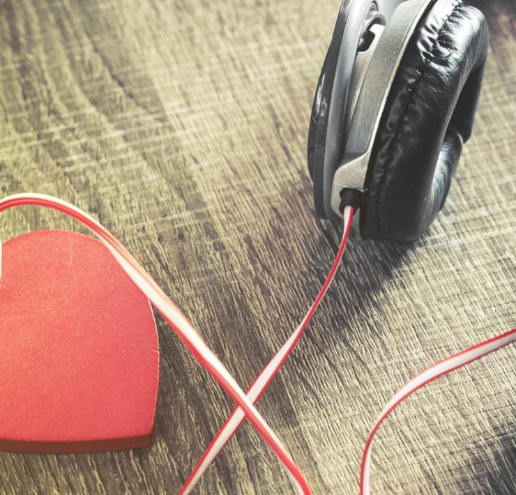 A pair of headphones plugged into a heart to represent massage music for couples to use on Valentine's Day.