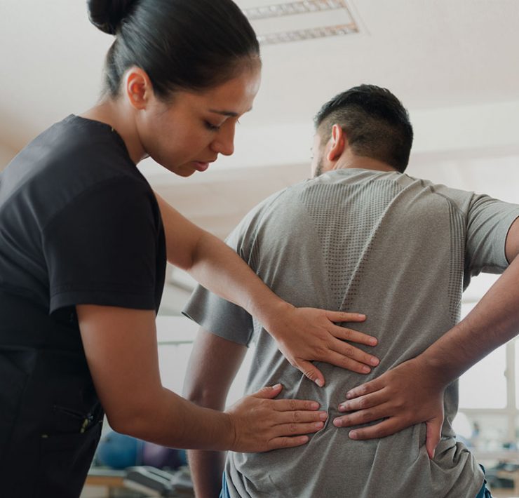 A registered massage therapist with an NPI number working on treating her patient.