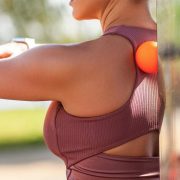 A woman standing outside in athletic wear.