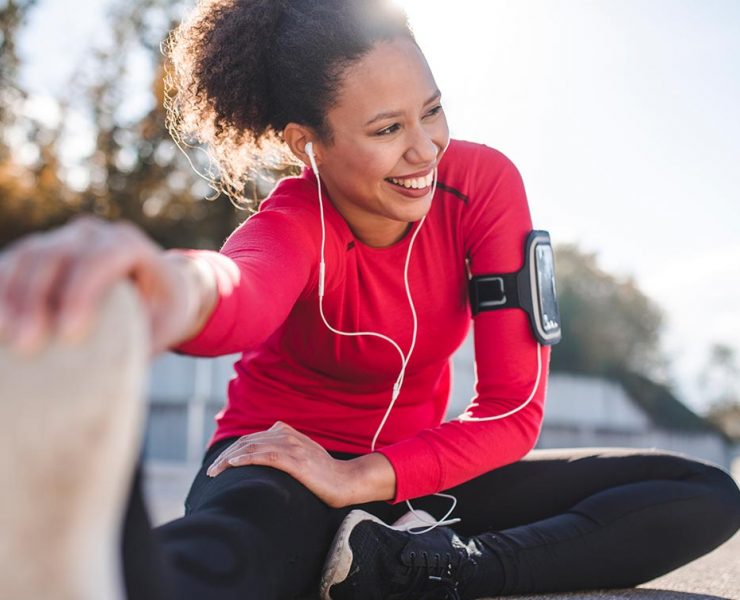 A runner taking a break to stretch out her leg muscles.