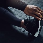 A woman stretching out her legs before she begins her workout.