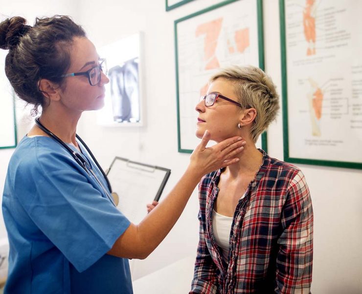 A woman getting a check-up with her doctor to assess to prognosis of her autoimmune disease.