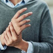 A woman rubbing her hand due to pain from her carpal tunnel syndrome.