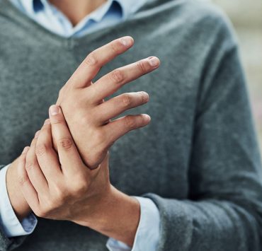 A woman rubbing her hand due to pain from her carpal tunnel syndrome.