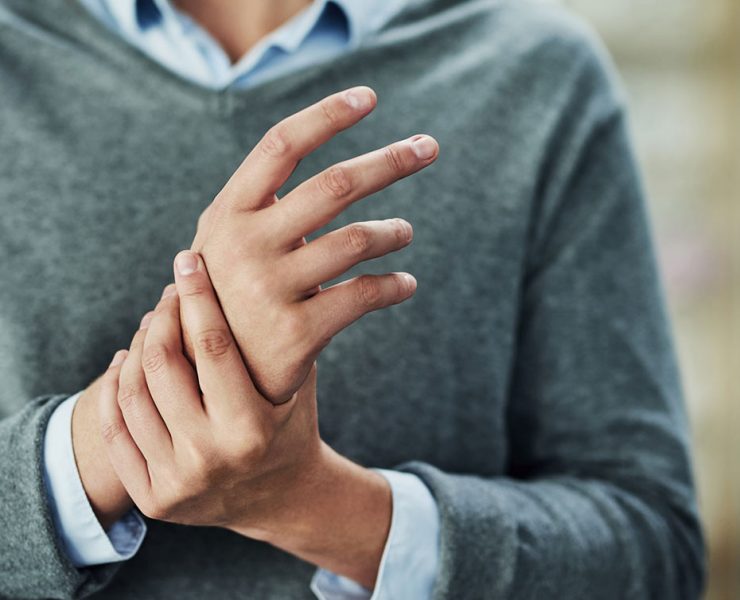 A woman rubbing her hand due to pain from her carpal tunnel syndrome.