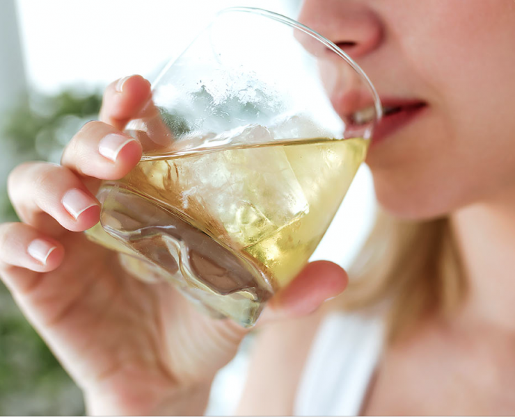 a woman drinking a glass of wine.
