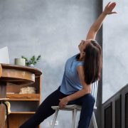 A woman stretching after her nonstop work flow.