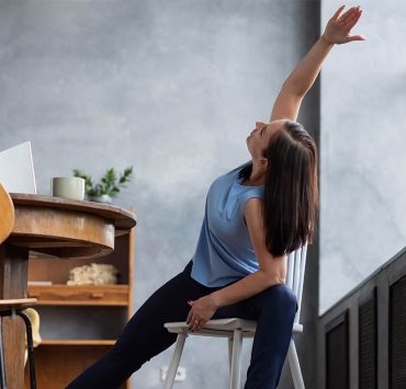 A woman stretching after her nonstop work flow.
