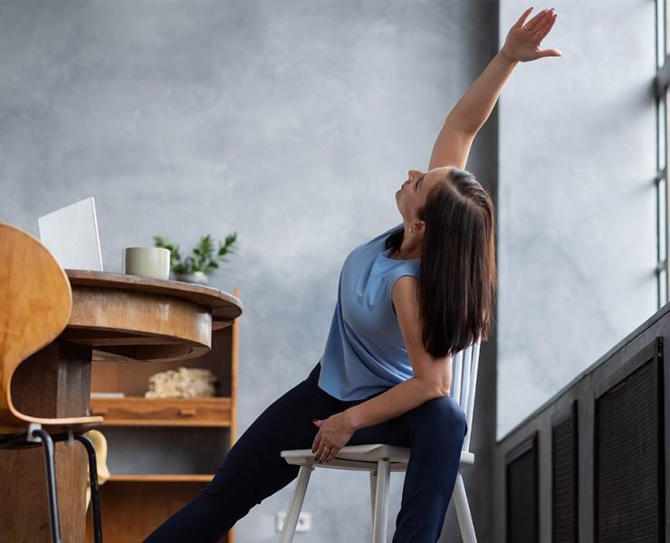 A woman stretching after her nonstop work flow.