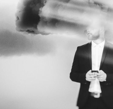 A man in a suit with his face blurred out to demonstrate brain fog.