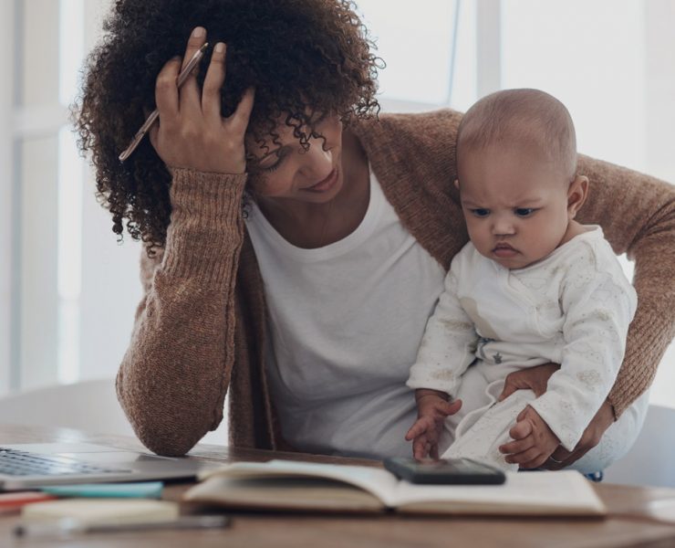 A mother who is dealing with stress and burnout trying to care for her baby while also working from home.
