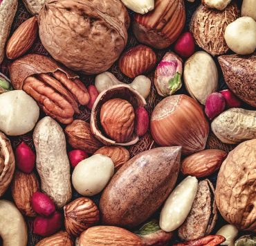 An variety of different nuts pilled together.