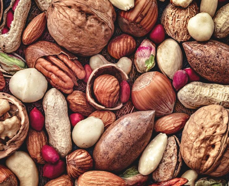 An variety of different nuts pilled together.